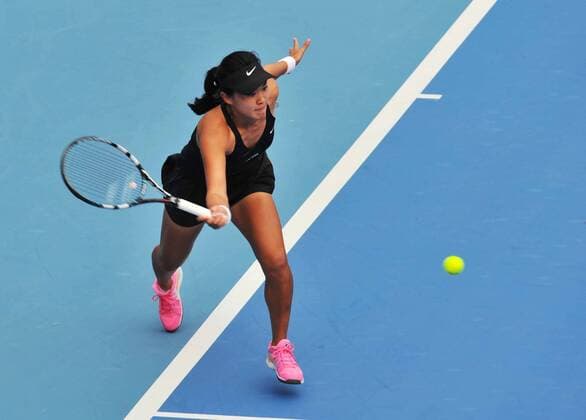 Zhu Lin of China returns a hit during the women s singles 2nd round match at the 2014 China Open in Beijing, capital of China, on Sept. 30, 2014. LixWen 