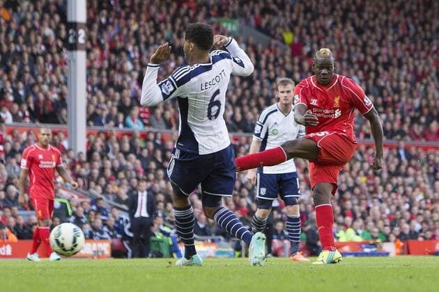 Mario Balotelli of Liverpool fires a shot at goal past West Brom s Joleon Loscott - Liverpool FC vs. West Bromwich Albion - Barclay s Premier League - Anfield - Liverpool - 04 10 2014 Pic PhilipxOldham Sportimage EDITORIAL USE ONLY. No use with unauthorised audio, video, data, fixture lists, club league logos or live services. Online in-match use limited to 120 images, no video emulation. No use in betting, games or single club league player publications.