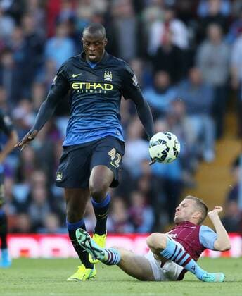 Yaya Toure of Manchester City tackled by Tom Cleverley of Aston Villa - Barclays Premier League - Aston Villa vs Manchester City - - England - 4th October 2014 - Picture SimonxBellis Sportimage EDITORIAL USE ONLY. No use with unauthorised audio, video, data, fixture lists, club league logos or live services. Online in-match use limited to 120 images, no video emulation. No use in betting, games or single club league player publications.
