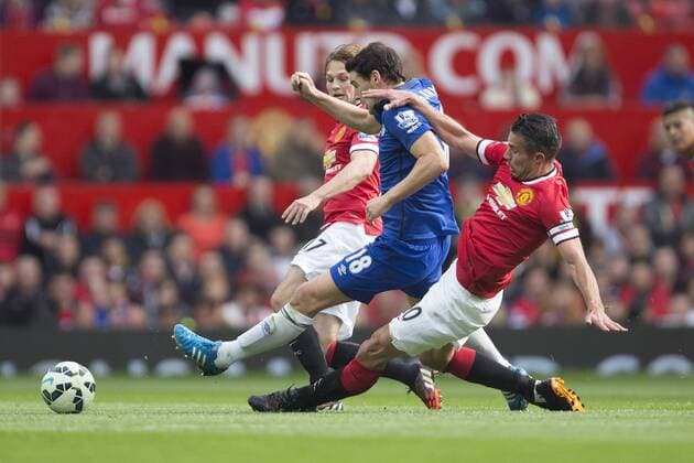 Robin van Persie of Manchester United earns a yellow card for his challenge on Gareth Barry of Everton - Manchester United vs. Everton - Barclay s Premier League - Old Trafford - Manchester - 04 10 2014 Pic Philip Oldham Sportimage EDITORIAL USE ONLY. No use with unauthorised audio, video, data, fixture lists, club league logos or live services. Online in-match use limited to 120 images, no video emulation. No use in betting, games or single club league player publications.
