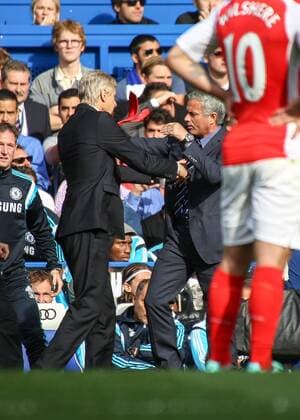 Football - 2014 2015 Premier League - Chelsea vs. Arsenal Jose Mourinho, Manager, of Chelsea FC ans Arsene Wenger,Manager, of Arsenal FC get physical at Stamford Bridge Colorsport Daniel Bearham  CHE_ARS