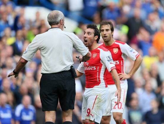 Arsenal s Santi Cazorla argues with referee Martin Atkinson - Barclays Premier League - Chelsea Vs Arsenal - Stamford Bridge - England - 5th October 2014 - EDITORIAL USE ONLY. No use with unauthorised audio, video, data, fixture lists, club league logos or live services. Online in-match use limited to 120 images, no video emulation. No use in betting, games or single club league player publications.