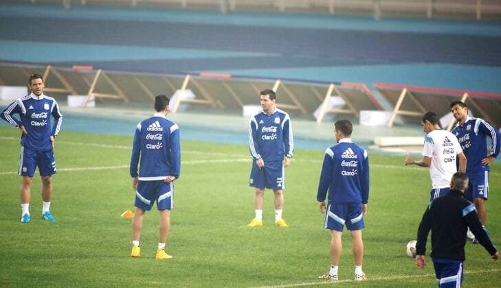 Lionel Messi, third left, and teammates of Argentina take part in a training session in heavy smog for the Americas Super Derby - also known as Superclasico de las Americas, in Beijing, 9 October 2014.  20141009_31540