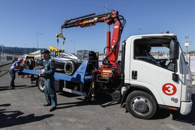 SOCHI, RUSSIA. OCTOBER 11, 2014. A McLaren s car is loaded onto a tow truck after a practice session ahead of the 2014 Formula One Russian Grand Prix at the Sochi Autodrom racing circuit. SergeixSavostyanov TASS  premiumd Highlight RE151940