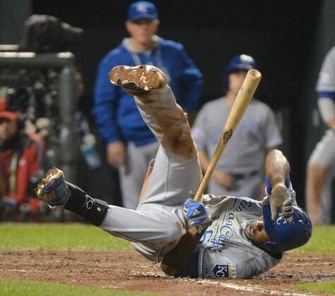 Kansas City Royals Lorenzo Cain falls to the ground after fouling a ball off himself in the seventh inning against the Baltimore Orioles in game 2 of the American League Championship Series at Orioles Park at Camden Yards in Baltimore, Maryland on October 11, 2014.  BAL20141011225