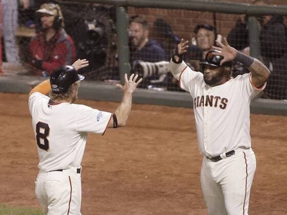 San Francisco Giants Hunter Pence (L) celebrates with Pablo Sandoval after they scored on a double by Juan Perez off Kansas City Royals pitcher Wade Davis in the eighth inning of game 5 of the World Series at AT&T Park in San Francisco on October 26, 2014. The Giants defeated the Royals 5-0.  SFP2014102606
