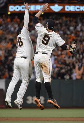 San Francisco Giants Pablo Sandoval (L) and Brandon Belt leap to high five celebrating their win against the Kansas City Royals during game 5 of the World Series at AT&T Park in San Francisco on October 26, 2014. The Giants took the pivotal game 5 beating the Royals 5-0 and now lead the series 3-2.  SXP2014102648