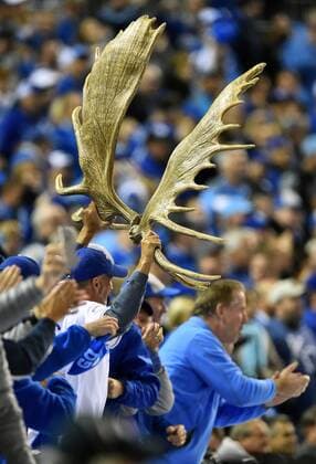 Kansas City Royals third baseman Mike Moustakas fan holds high gilded moose antlers after Moustakas hit a solo home run against the San Francisco Giants during the seventh inning of game 6 of the World Series at Kaufman Stadium in Kansas City, Missouri on October 28, 2014. The Giants hold a 3-2 series lead and need only one win against the Royals to win the World Series.  KCP2014102878
