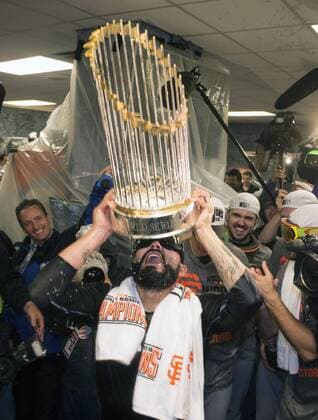 San Francisco Giants Sergio Romo celebrates with the Commissioner Trophy after the Giants won the 2014 World Series, defeating the Kansas City Royals at Kaufman Stadium in Kansas City, Missouri on October 28, 2014.  WAP20141029304