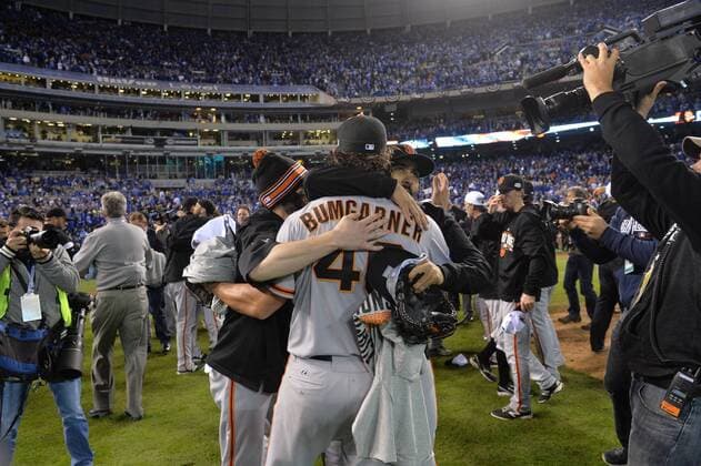 San Francisco Giants pitcher and World Series MVP Madison Bumgarner hugs teammate after the final out against the Kansas City Royals in game 7 of the World Series at Kauffman Stadium in Kansas City, Missouri on October 29, 2014. San Francisco wins the World Series defeating Kansas City 3-2.  KCP2014102988