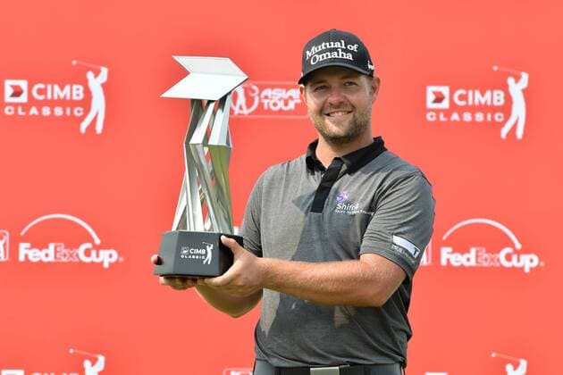 (141102) -- KUALA LUMPUR, Nov. 2, 2014 -- Ryan Moore of the US poses with his trophy after winning the 2014 CIMB Classic golf tournament in Kuala Lumpur on November 2, 2014. ) (SP)MALAYSIA-KUALA LUMPUR-GOLF ChongxVoonxChung 