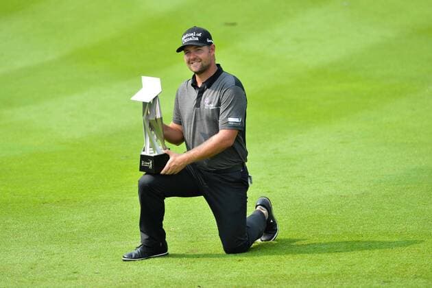 (141102) -- KUALA LUMPUR, Nov. 2, 2014 -- Ryan Moore of the US poses with his trophy after winning the 2014 CIMB Classic golf tournament in Kuala Lumpur on November 2, 2014. ) (SP)MALAYSIA-KUALA LUMPUR-GOLF ChongxVoonxChung 