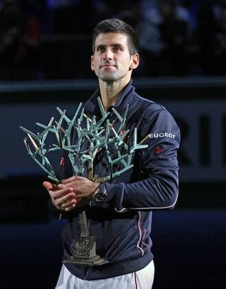 Novak Djokovic of Serbia holds the championship trophy after winning his finals match at the BNP Paribas Masters in Paris on November 2, 2014.  PAR20141102728