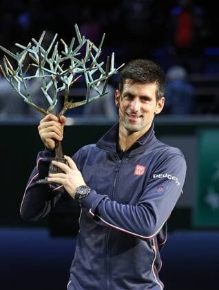 Novak Djokovic of Serbia holds the championship trophy after winning his finals match at the BNP Paribas Masters in Paris on November 2, 2014.  PAR20141102734