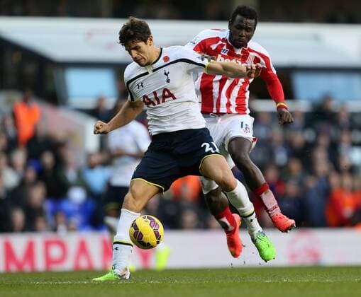 Tottenham s Ferderico Fazio tussles with Stoke s Mame Diouf - Barclays Premier League - Tottenham Hotspur vs Stoke City- White Hart Lane - London - England - 9th November 2014 - Picture David Klein Sportimage EDITORIAL USE ONLY. No use with unauthorised audio, video, data, fixture lists, club league logos or live services. Online in-match use limited to 120 images, no video emulation. No use in betting, games or single club league player publications.