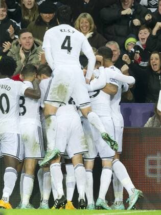 Football - 2014 2015 Premier League - Swansea City vs. Arsenal Gylfi Sigurdsson of Swansea celebrates scoring their 1st goal at The Liberty Stadium. COLORSPORT WINSTON BYNORTH 