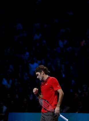 Roger Federer of Switzerland celebrates during the ATP Tennis Herren World Tour Finals Group B match in London, Britain, on Nov. 9, 2014. (SP)BRITAIN-LONDON-TENNIS-ATP WORLD TOUR FINALS-FEDERER VS RAONIC HanxYan 