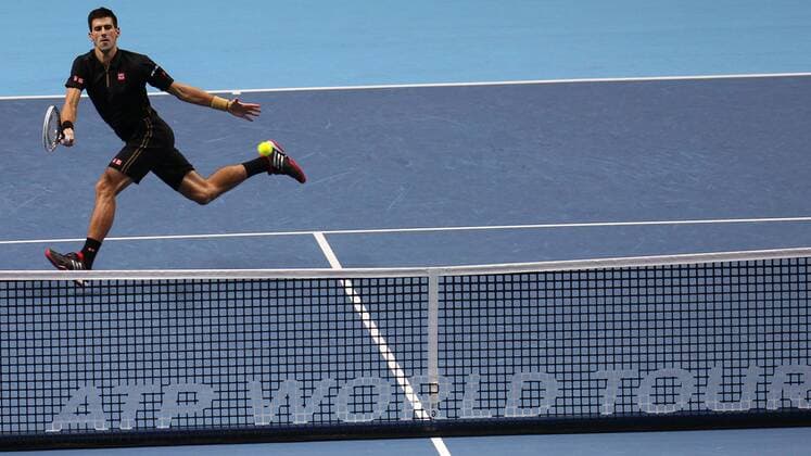 Tennis - 2014 ATP Tennis Herren World Tour Finals at The O2 - Day Three, Group A Novak Djokovic with a drop shot over the ATP Tennis Herren World Tour net 
