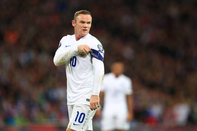 Wayne Rooney of England tugs at his captain s armband - England vs. Slovenia - UEFA Euro 2016 Qualifying - Wembley Stadium - London - 15 11 2014 Pic Philip Oldham Sportimage EDITORIAL USE ONLY. No use with unauthorised audio, video, data, fixture lists, club league logos or live services. Online in-match use limited to 120 images, no video emulation. No use in betting, games or single club league player publications.