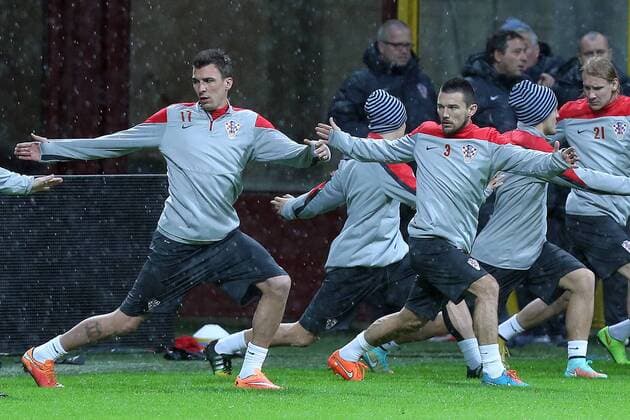 CRO football training - Milan, Italy 15.11.2014., Milan, Italy - Mario Mandzukic Danijel Pranjic at Short training of Croatian football team during heavy rain on the San Siro stadium. After press conference it was decided that training will be held.  GoranxStanzl PIXSELL