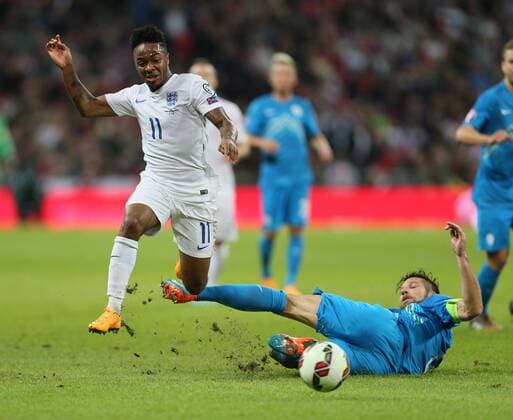 England s Raheem Sterling tussles with Slovenia s Bostjan Cesar - International European Qualifier - England vs Slovenia- Wembley Stadium - London - England - 15th November 2014 - Picture David Klein Sportimage EDITORIAL USE ONLY. No use with unauthorised audio, video, data, fixture lists, club league logos or live services. Online in-match use limited to 120 images, no video emulation. No use in betting, games or single club league player publications.