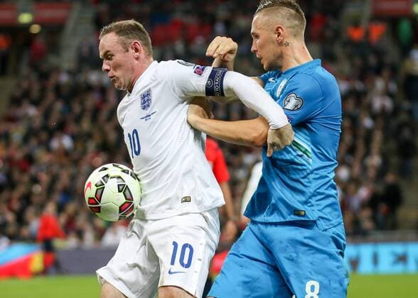 Football - 2014 2015 European Qualifier - Group E: England vs. Slovenia, England s Wayne Rooney holds off Slovenia s Jasmin Kurtic at Wembley Stadium Colorsport Daniel Bearham  ENG_SLO