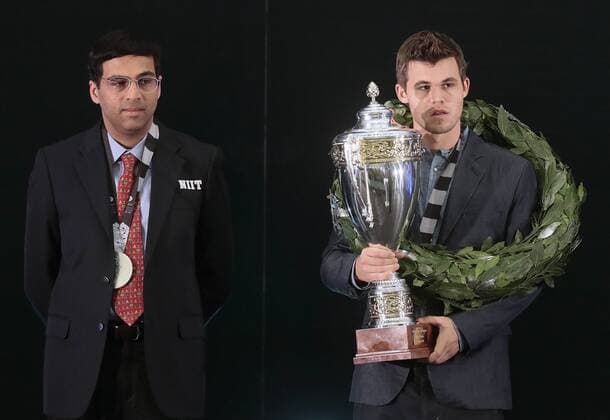 SOCHI, RUSSIA.NOVEMBER 25, 2014. Indian chess player Viswanathan (Vishy) Anand (L) looks on as chess champion Magnus Carlsen of Norway receives his trophy after winning the FIDE World Chess Championship 2014.  premiumd RE155C50