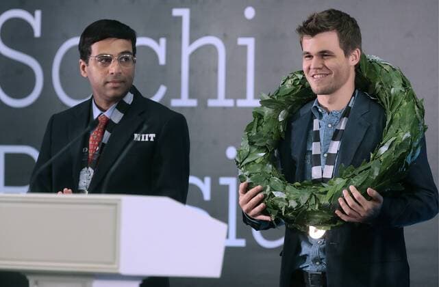 SOCHI, RUSSIA.NOVEMBER 25, 2014. Indian chess player Viswanathan (Vishy) Anand (L) looks on as chess champion Magnus Carlsen of Norway receives his trophy after winning the FIDE World Chess Championship 2014.  premiumd RE155CE9