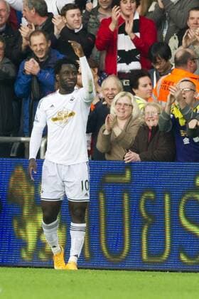Football - 2014 2015 Premier League - Swansea City vs. Crystal Palace Wilfried Bony of Swansea scores their 1st goal and celebrates in the corner at The Liberty Stadium. COLORSPORT WINSTON BYNORTH 