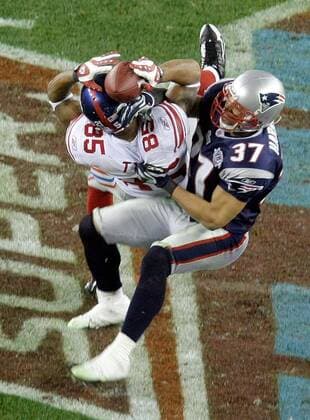 Feb. 3, 2008 - New York Giants receiver David Tyree (85) hauls in a long pass against the New England Patriots Rodney Harrison (37) on the game-winning drive in a 17-14 victory over the New England Patriots in the second half of Super Bowl XLII at University of Phoenix Stadium in Glendale, Arizona, on Sunday, February 3, 2008. (Mark Cornelison MCT) News Archive - Feb. 3, 2008 - ZUMAm67_
