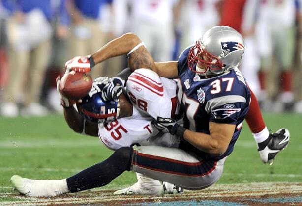 Feb. 3, 2008 - New York Giants receiver David Tyree (85) holds onto the ball as he is brought down by the New England Patriots Rodney Harrison (37) in a 17-14 Giants victory in Super Bowl XLII at University of Phoenix Stadium in Glendale, Arizona, on Sunday, February 3, 2008. (Karl Mondon MCT) News Archive - Feb. 3, 2008 - ZUMAm67_