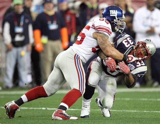Feb. 3, 2008 - The New England Patriots Kevin Faulk (33) is tackled by the New York Giants Kawika Mitchell (55) in the first half of Super Bowl XLII at University of Phoenix Stadium in Glendale, Arizona, on Sunday, February 3, 2008. (Gary W. Green MCT) News Archive - Feb. 3, 2008 - ZUMAm67_