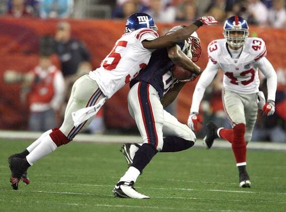Feb. 3, 2008 - The New England Patriots Randy Moss (81) gets a first down despite the defense of the New York Giants Kevin Dockery (35) in the first half of Super Bowl XLII at University of Phoenix Stadium in Glendale, Arizona, on Sunday, February 3, 2008. (Gary W. Green MCT) News Archive - Feb. 3, 2008 - ZUMAm67_