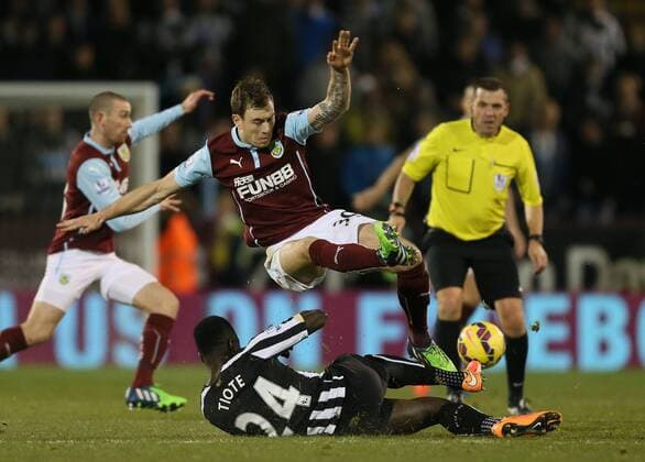 Ashley Barnes of Burnley tackled by Cheik Ismael Tiote of Newcastle United - Barclays Premier League - Burnley vs Newcastle Utd - Turf Moor Stadium - England - 2nd December 2014 - EDITORIAL USE ONLY. No use with unauthorised audio, video, data, fixture lists, club league logos or live services. Online in-match use limited to 120 images, no video emulation. No use in betting, games or single club league player publications.