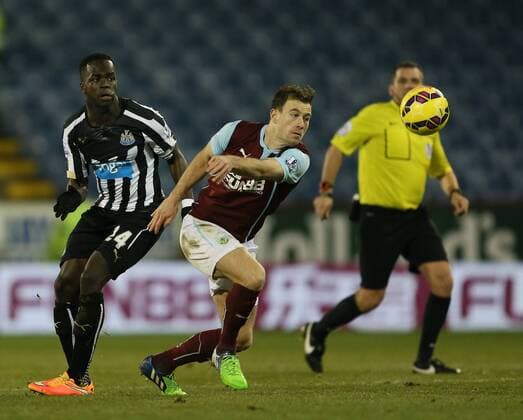 Cheik Ismael Tiote of Newcastle United challenges Ashley Barnes of Burnley - Barclays Premier League - Burnley vs Newcastle Utd - Turf Moor Stadium - England - 2nd December 2014 - EDITORIAL USE ONLY. No use with unauthorised audio, video, data, fixture lists, club league logos or live services. Online in-match use limited to 120 images, no video emulation. No use in betting, games or single club league player publications.