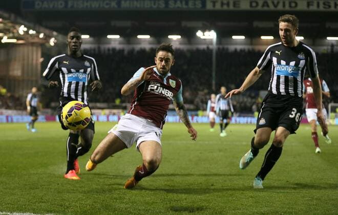 Danny Ings of Burnley chases after the ball past Massadio Haidara and Paul Dummett of Newcastle United - Barclays Premier League - Burnley vs Newcastle Utd - Turf Moor Stadium - England - 2nd December 2014 - EDITORIAL USE ONLY. No use with unauthorised audio, video, data, fixture lists, club league logos or live services. Online in-match use limited to 120 images, no video emulation. No use in betting, games or single club league player publications.