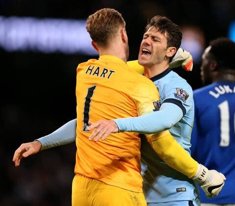 Joe Hart of Manchester City and Martin Demichelis of Manchester City celebrate the win - Barclays Premier League - Manchester City vs FC Everton - Etihad Stadium - Manchester - England - 6th December 2014 - EDITORIAL USE ONLY. No use with unauthorised audio, video, data, fixture lists, club league logos or live services. Online in-match use limited to 120 images, no video emulation. No use in betting, games or single club league player publications.