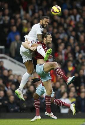 West Ham s Andy Carroll tussles with Swansea s Kyle Bartley Barclays Premier League- West Ham United vs Swansea City - Upton Park - England - 7th December 2014 - Picture David Klein Sportimage EDITORIAL USE ONLY. No use with unauthorised audio, video, data, fixture lists, club league logos or live services. Online in-match use limited to 120 images, no video emulation. No use in betting, games or single club league player publications.