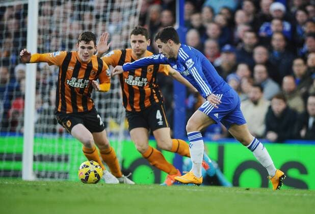 Football - 2014 2015 Premier League - Chelsea FC vs. Hull City Chelsea s Eden Hazard shots past Andrew Robertson and Alex Bruce at Stamford Bridge. 