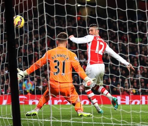 Arsenal s Olivier Giroud scoring his sides third goal Barclays Premier League- Arsenal FC vs Newcastle United - Emirates Stadium - England - 13th December 2014 - EDITORIAL USE ONLY. No use with unauthorised audio, video, data, fixture lists, club league logos or live services. Online in-match use limited to 120 images, no video emulation. No use in betting, games or single club league player publications.