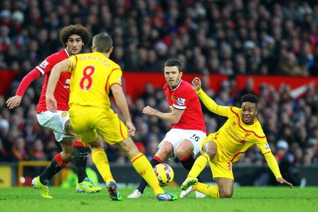 14.12.2014. Manchester, England. Premier League. Manchester United ManU versus FC Liverpool. Marouane Fellaini and Michael Carrick (Man) battle for the ball with Steven Gerrard and Raheem Sterling (Liverpool) in midfield xPaulxKeevilx  ActionPlus11583203