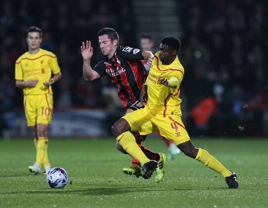 Bournemouth s Yann Kermorgant tussles with Liverpool s Kolo Toure Capital One Cup- Bournemouth vs Liverpool - Goldsands Stadium - England - 17th December 2014 - Picture David Klein Sportimage EDITORIAL USE ONLY. No use with unauthorised audio, video, data, fixture lists, club league logos or live services. Online in-match use limited to 120 images, no video emulation. No use in betting, games or single club league player publications.