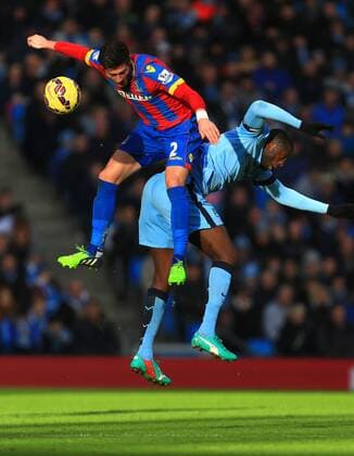 Joel Ward of Crystal Palace beats Yaya Toure of Manchester City in the air - Manchester City vs. Crystal Palace - Barclay s Premier League - Etihad Stadium - Manchester - 20 12 2014 EDITORIAL USE ONLY. No use with unauthorised audio, video, data, fixture lists, club league logos or live services. Online in-match use limited to 120 images, no video emulation. No use in betting, games or single club league player publications.
