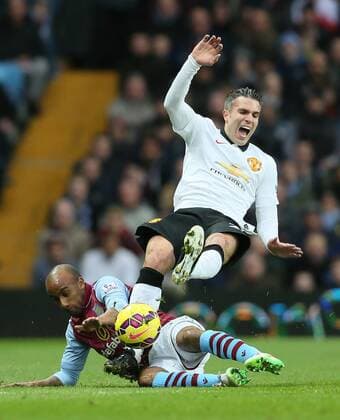 Robin van Persie of Manchester United ManU tackled hard by Fabian Delph of Aston Villa - Barclays Premier League - Aston Villa vs Manchester United Villa Park Stadium - Birmingham - England - 20th December 2014 - Picture SimonBellis Sportimage EDITORIAL USE ONLY. No use with unauthorised audio, video, data, fixture lists, club league logos or live services. Online in-match use limited to 120 images, no video emulation. No use in betting, games or single club league player publications.