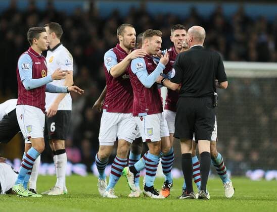 Matthew Lowton of Aston Villa confronts referee Lee Mason following his red card for Gabriel Agbonlahor of Aston Villa - Barclays Premier League - Aston Villa vs Manchester United Villa Park Stadium - Birmingham - England - 20th December 2014 - Picture SimonBellis Sportimage EDITORIAL USE ONLY. No use with unauthorised audio, video, data, fixture lists, club league logos or live services. Online in-match use limited to 120 images, no video emulation. No use in betting, games or single club league player publications.