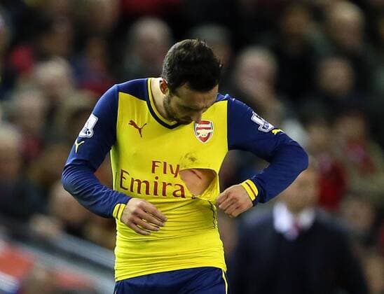 Aktuell Fußball, England, Premier League, Santi Carzola vom FC Arsenal mit kurioser Verletzung Arsenal s Santi Cazorla looks at his cut and ripped shirt after a high tackle Barclays Premier League - Liverpool FC vs Arsenal FC - Anfield - England - 21st December 2014 - EDITORIAL USE ONLY. No use with unauthorised audio, video, data, fixture lists, club league logos or live services. Online in-match use limited to 120 images, no video emulation. No use in betting, games or single club league player publications.