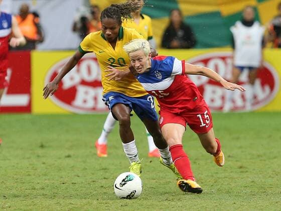 Megan Rapinoe (R) of the United States breaks through during a match between Brazil and the United States of the 2014 International Women s Football Tournament of Brasilia in Brasilia, capital of Brazil, Dec. 21, 2014. Brazil claimed the title after a 0-0 draw over the United States on Sunday. ) (SP)BRAZIL-BRASILIA-WOMEN S FOOTBALL TOURNAMENT-BRAZIL VS USA XuxZijian 