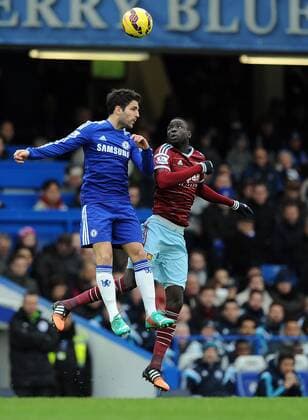 Cesc Fabregas of Chelsea is challenged by Cheikhou Kouyate of West Ham United - Barclays Premier League - Chelsea vs West Ham United - Stamford Bridge Stadium - London - England - 26th December 2014 - Pic Robin Parker Sportimage EDITORIAL USE ONLY. No use with unauthorised audio, video, data, fixture lists, club league logos or live services. Online in-match use limited to 120 images, no video emulation. No use in betting, games or single club league player publications. DSC_7676.JPG