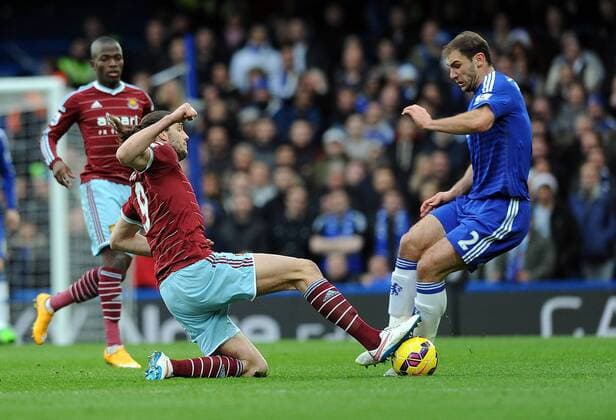 Andy Carroll of West Ham United tackles Branislav Ivanovic of Chelsea - Barclays Premier League - Chelsea vs West Ham United - Stamford Bridge Stadium - London - England - 26th December 2014 - Pic Robin Parker Sportimage EDITORIAL USE ONLY. No use with unauthorised audio, video, data, fixture lists, club league logos or live services. Online in-match use limited to 120 images, no video emulation. No use in betting, games or single club league player publications. DSC_7764.JPG