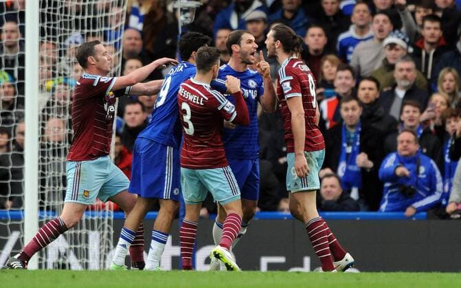 Branislav Ivanovic of Chelsea argues with Andy Carroll of West Ham United after dive in penalty area - Barclays Premier League - Chelsea vs West Ham United - Stamford Bridge Stadium - London - England - 26th December 2014 - Pic Robin Parker Sportimage EDITORIAL USE ONLY. No use with unauthorised audio, video, data, fixture lists, club league logos or live services. Online in-match use limited to 120 images, no video emulation. No use in betting, games or single club league player publications. DSC_8105.JPG